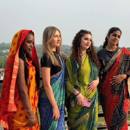 Group of volunteers wearing colourful traditional clothing during a cultural exchange activity