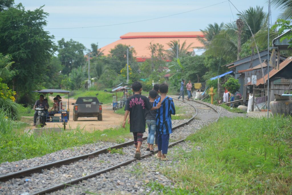 Children walking by some train tracks for the Cambodian Norries