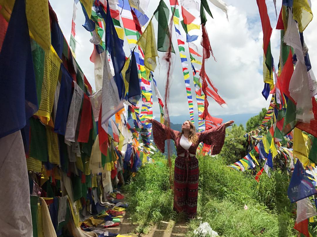 A woman standing among the flags in Nepal