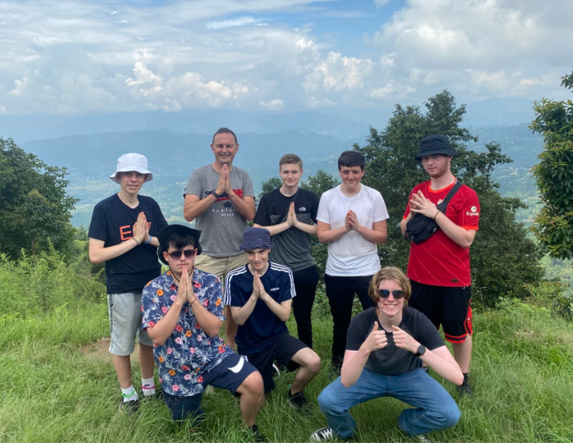 Team members posing in front of mountains - Challenges Abroad